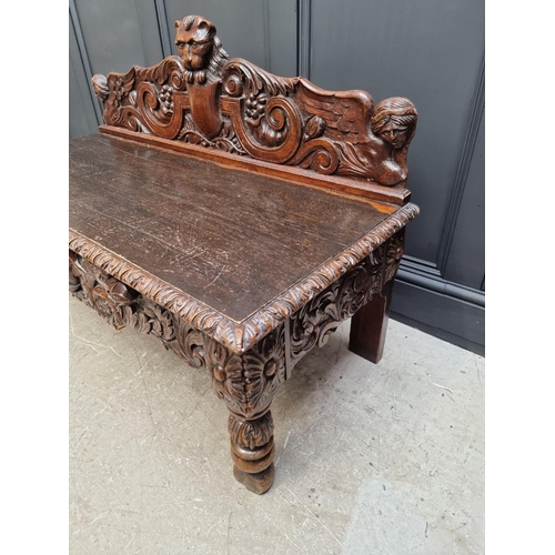 1141 - A late Victorian carved oak low hall table, with a lateral frieze drawer, 127cm wide, (reduced in he... 