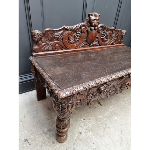 1141 - A late Victorian carved oak low hall table, with a lateral frieze drawer, 127cm wide, (reduced in he... 