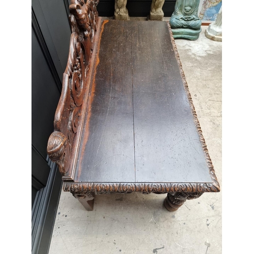 1141 - A late Victorian carved oak low hall table, with a lateral frieze drawer, 127cm wide, (reduced in he... 