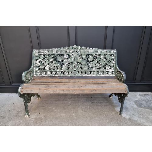 1144 - An old green painted cast iron garden bench, 131cm wide.