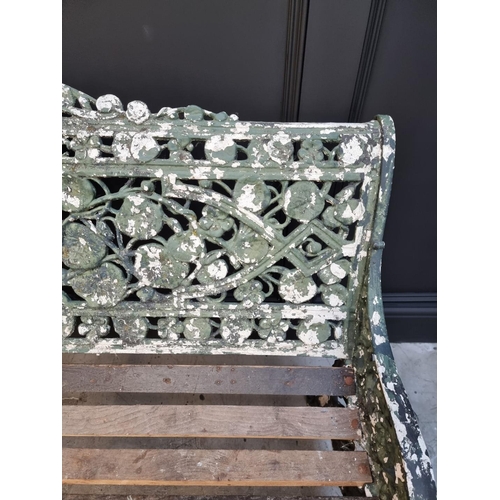 1144 - An old green painted cast iron garden bench, 131cm wide.