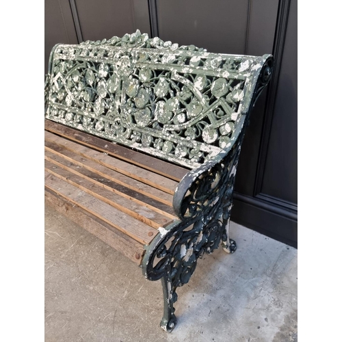 1144 - An old green painted cast iron garden bench, 131cm wide.