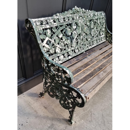 1144 - An old green painted cast iron garden bench, 131cm wide.