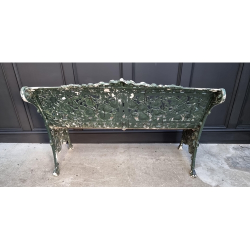 1144 - An old green painted cast iron garden bench, 131cm wide.