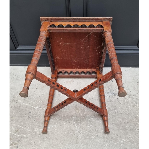 1160 - A George III elm circular tilt top tripod table, with one piece top, 63cm diameter, (one leg a.f.); ... 