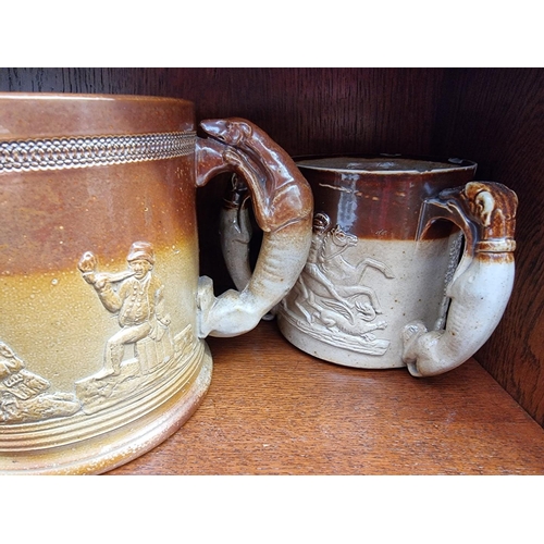 1257 - Two Victorian stoneware loving cups, largest 16.5cm high; and a similar tyg, (chips to each).&n... 