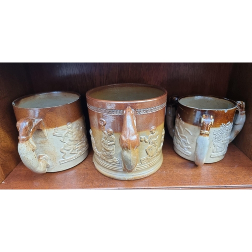 1257 - Two Victorian stoneware loving cups, largest 16.5cm high; and a similar tyg, (chips to each).&n... 