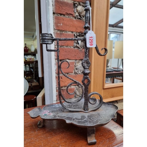 1259 - A forged steel pricket form candlestick, 34cm high.