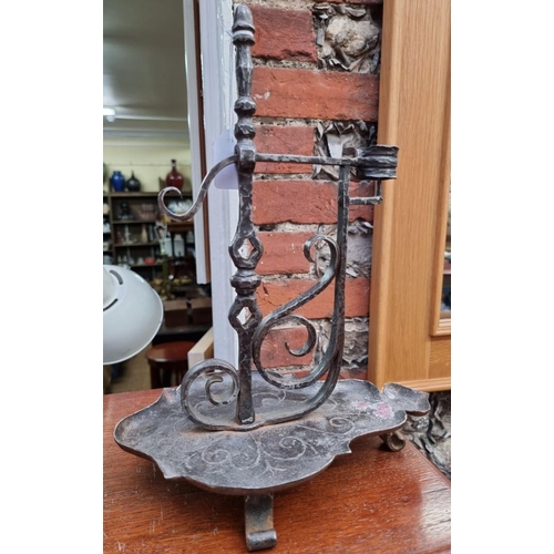 1259 - A forged steel pricket form candlestick, 34cm high.