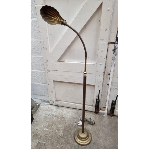 1265 - A vintage brass articulated standard lamp, with brass shell shade.