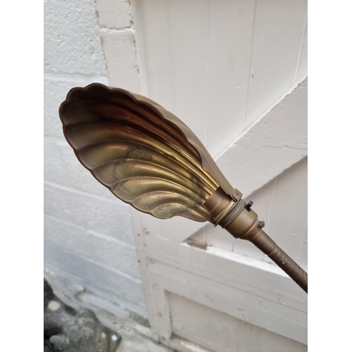 1265 - A vintage brass articulated standard lamp, with brass shell shade.