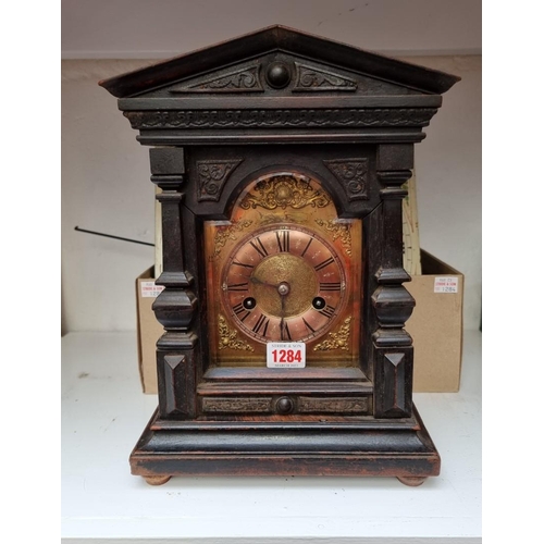 1284 - A 12in painted clock dial and 30 hour movement, with pendulum; together with another antique ebonize... 