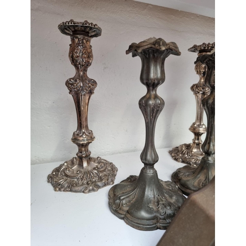 1286 - A pair of Old Sheffield plate candlesticks, 28.5cm high; together with another pair of candlesticks;... 