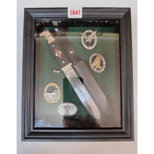 1641 - A reproduction German Third Reich Hitler Youth knife and sheath, framed with four badges.... 