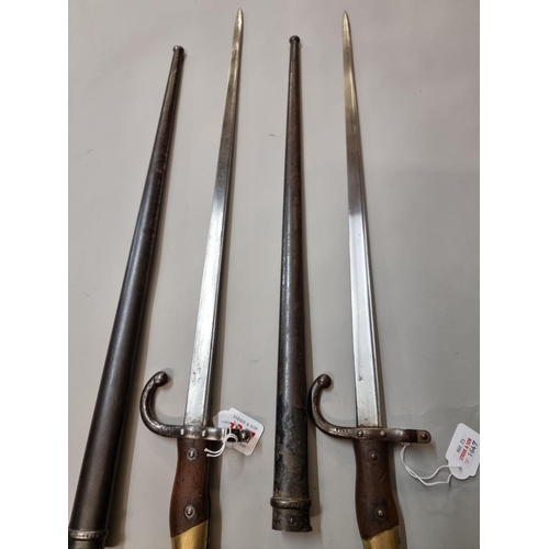 1647 - Two French T back bayonets and scabbards, dated 1875 and 1877, both marked St Etienne and numbered 1... 