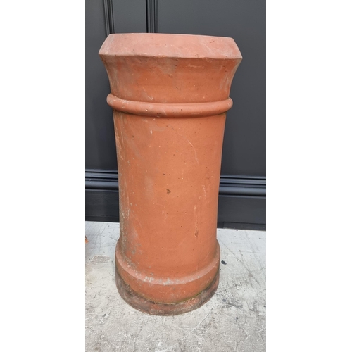 1694 - A terracotta chimney pot, 61cm high x 20cm wide; together with a similar chimney top.... 