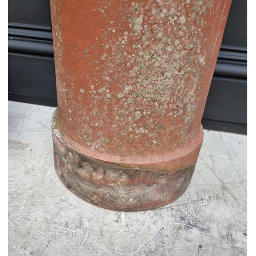 1694 - A terracotta chimney pot, 61cm high x 20cm wide; together with a similar chimney top.... 