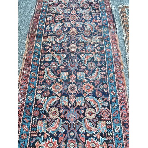 1000 - A large Persian runner, having floral central medallion, (a.f.), 490 x 94cm; together with a small C... 