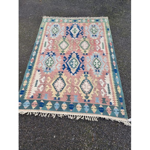 1002 - A Kelim rug, having geometric borders, 266 x 181cm.