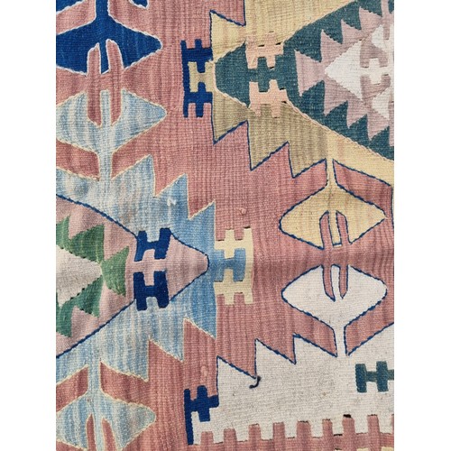 1002 - A Kelim rug, having geometric borders, 266 x 181cm.