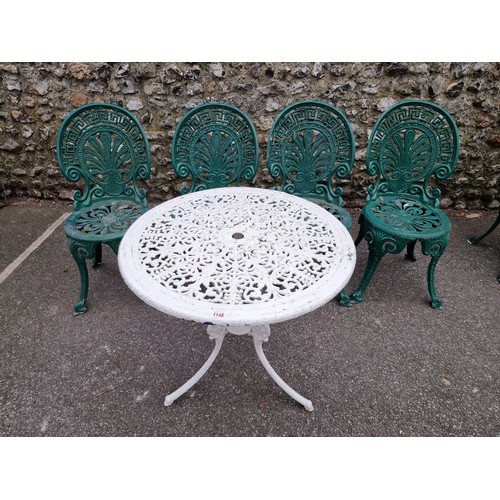 1148 - A white painted aluminium table, 64cm high x 69cm wide; together with a set of four green painted ch... 