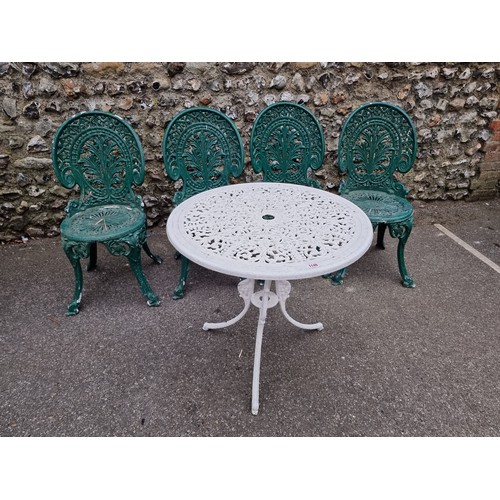 1149 - A white painted aluminium table, 64cm high x 69cm wide; together with a set of four green painted ch... 