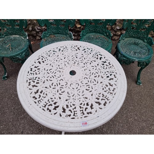 1149 - A white painted aluminium table, 64cm high x 69cm wide; together with a set of four green painted ch... 