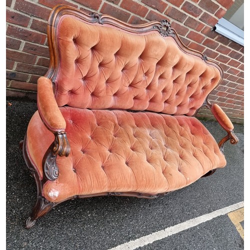 1090 - A Victorian carved walnut and button upholstered settee, (faults).