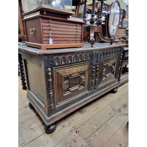 1060 - A 17th century oak panelled coffer, 135.5cm wide, (later panels to the front).