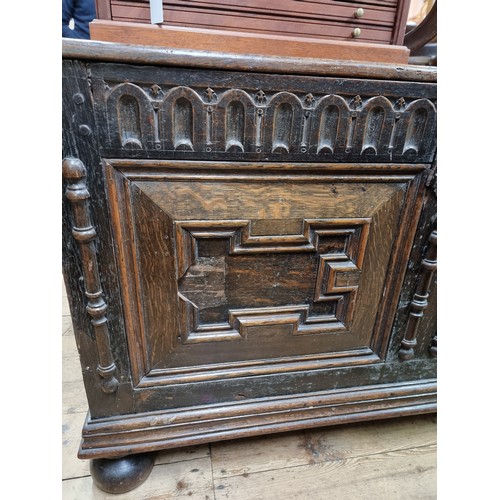 1060 - A 17th century oak panelled coffer, 135.5cm wide, (later panels to the front).