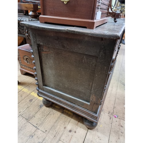 1060 - A 17th century oak panelled coffer, 135.5cm wide, (later panels to the front).