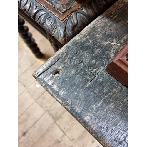 1060 - A 17th century oak panelled coffer, 135.5cm wide, (later panels to the front).