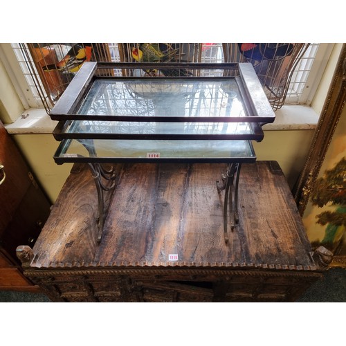 1114 - A nest of three steel and glass occasional tables, largest 54.5cm wide, (largest lacking glass)... 