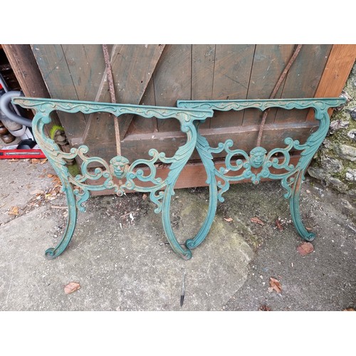 1157 - A pair of green painted cast iron table ends.