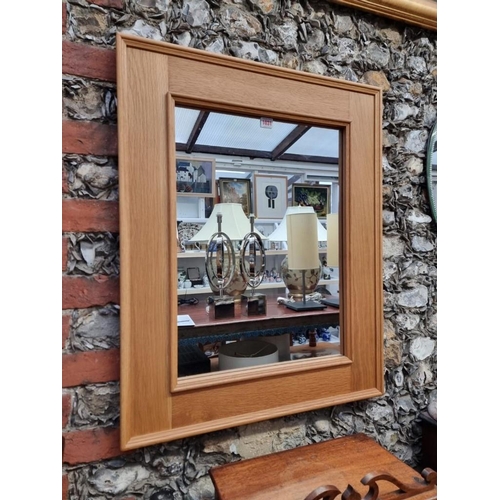 1031 - A contemporary pale oak rectangular framed wall mirror, 80 x 65cm.