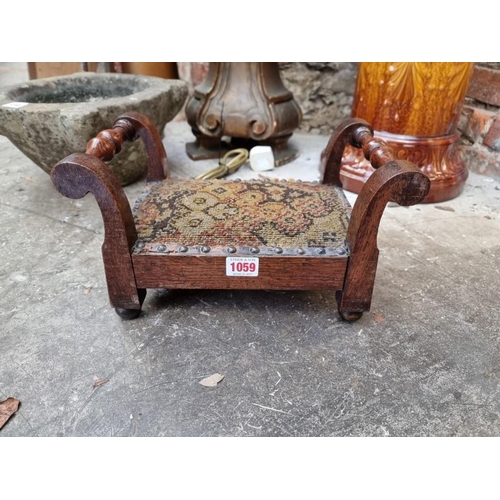 1059 - An early 20th century oak gout stool, on brass feet, 31.5cm wide.  