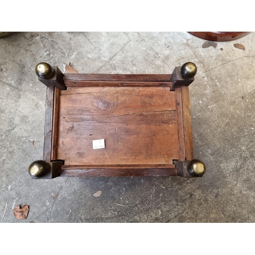 1059 - An early 20th century oak gout stool, on brass feet, 31.5cm wide.  