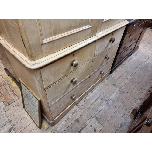 1082 - A 19th century pine linen press, enclosing four sliding trays, 130cm wide. 