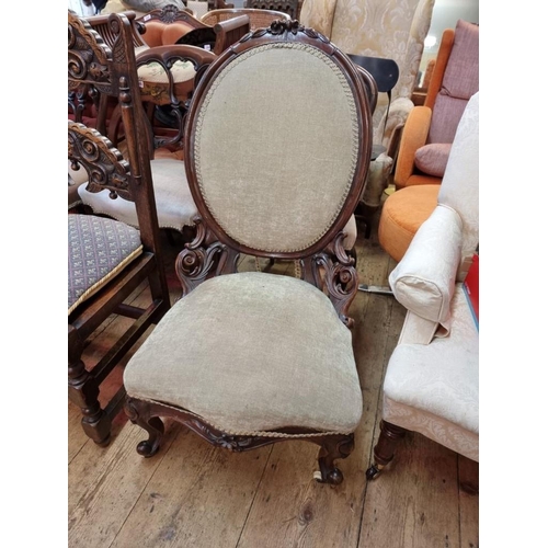 1099 - A Victorian carved walnut and upholstered low occasional chair. 