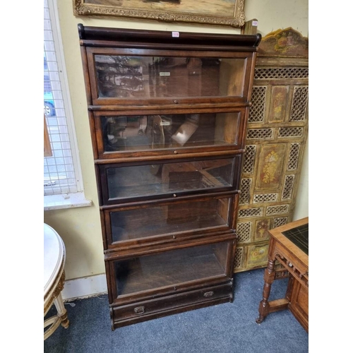 1119 - An early 20th century mahogany Globe Wernicke five tier sectional bookcase, with apron drawer, 86.5c... 