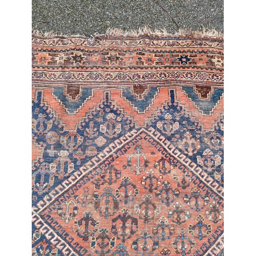 1001 - A Persian carpet, having three central medallions, borders having floral decoration, 303 x 208cm.... 