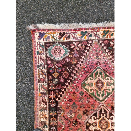 1009 - A Persian rug, having three central medallions, floral cartouches to each corner with animals t... 