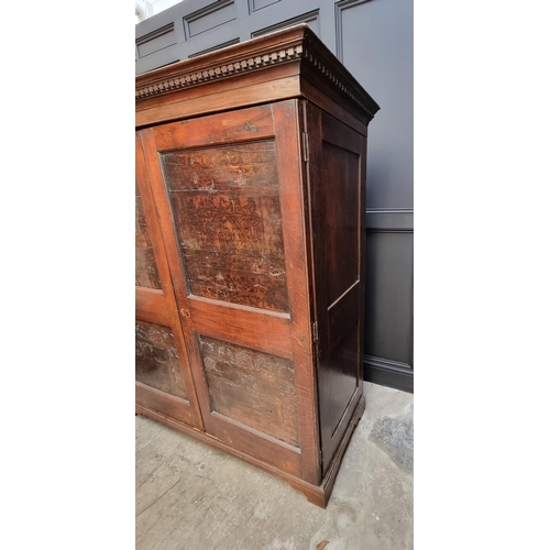 1020 - An 18th century oak press cupboard, incorporating 17th century Italian Cypress wood panels, 164cm wi... 