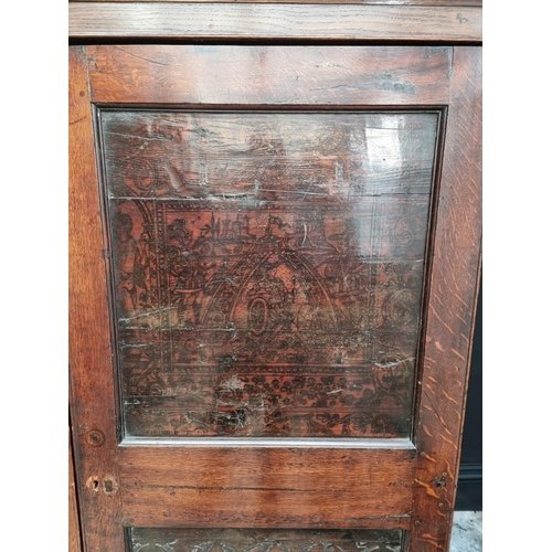 1020 - An 18th century oak press cupboard, incorporating 17th century Italian Cypress wood panels, 164cm wi... 