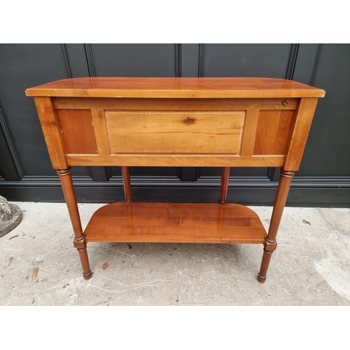 1022 - A reproduction cherry wood console table, labelled 'Anne de Morienne', 89cm wide. ... 