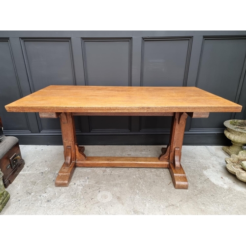 1023 - An oak trestle table, on chamfered supports, 152.5cm long.