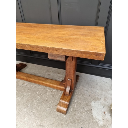 1023 - An oak trestle table, on chamfered supports, 152.5cm long.