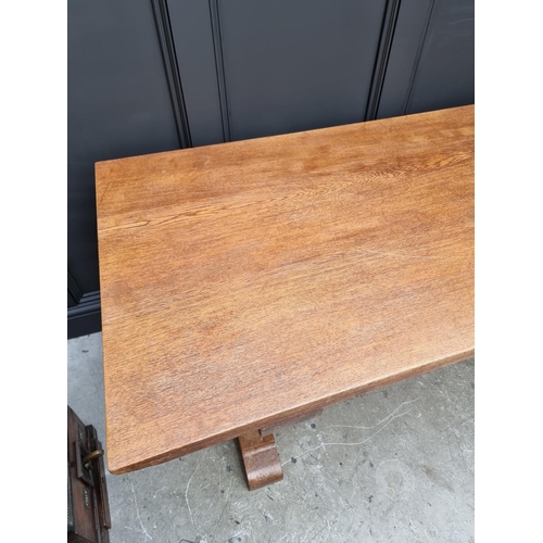 1023 - An oak trestle table, on chamfered supports, 152.5cm long.