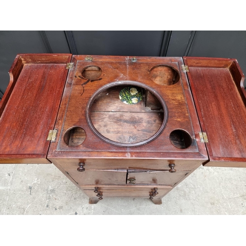 1027 - A George III mahogany and line inlaid wash stand, enclosing a rising mirror, 45cm wide.... 