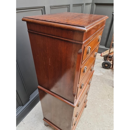 1028 - A small reproduction mahogany chest on chest, 48cm wide. 